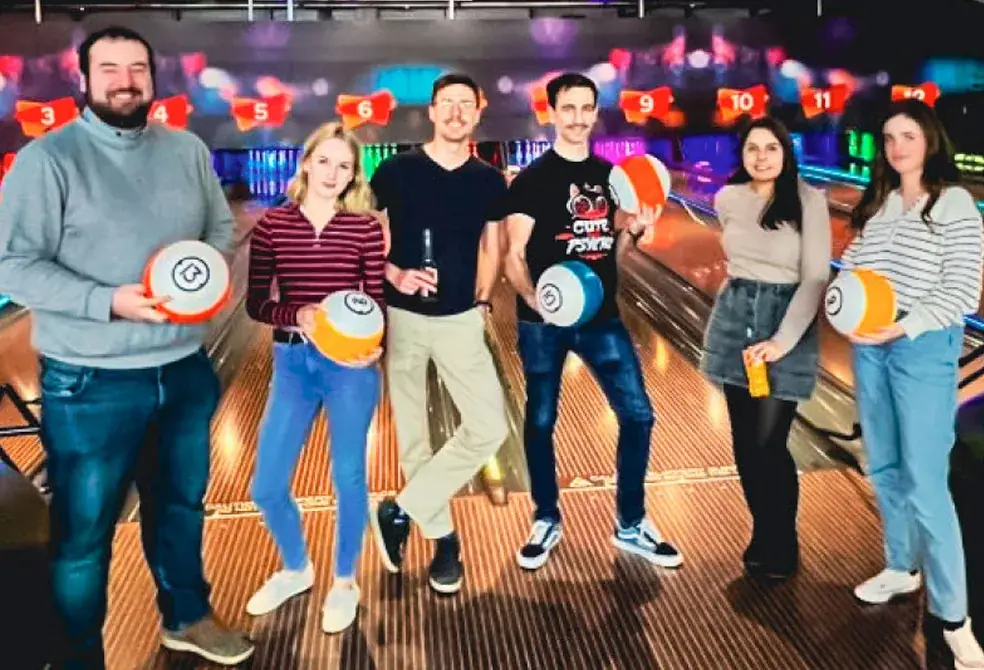 Friends holding bowling balls