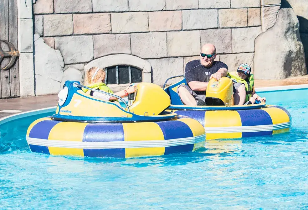 A dad and daughter in a bumper boat