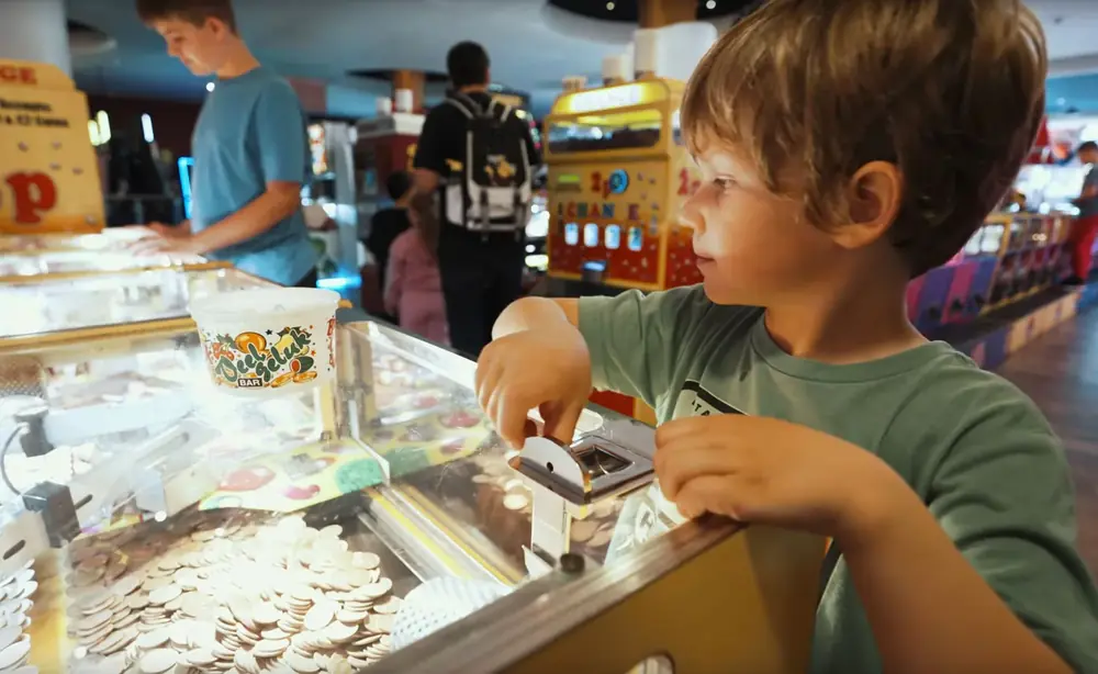 A child at an arcade machine